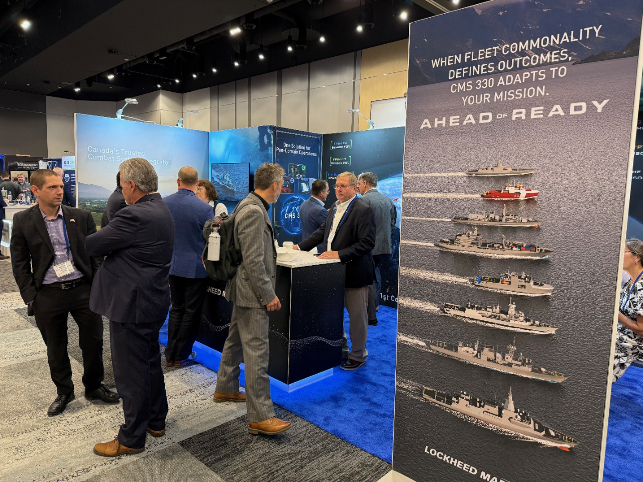 Group of people standing in front of the 2025 Lockheed Martin Canada DEFSEC booth