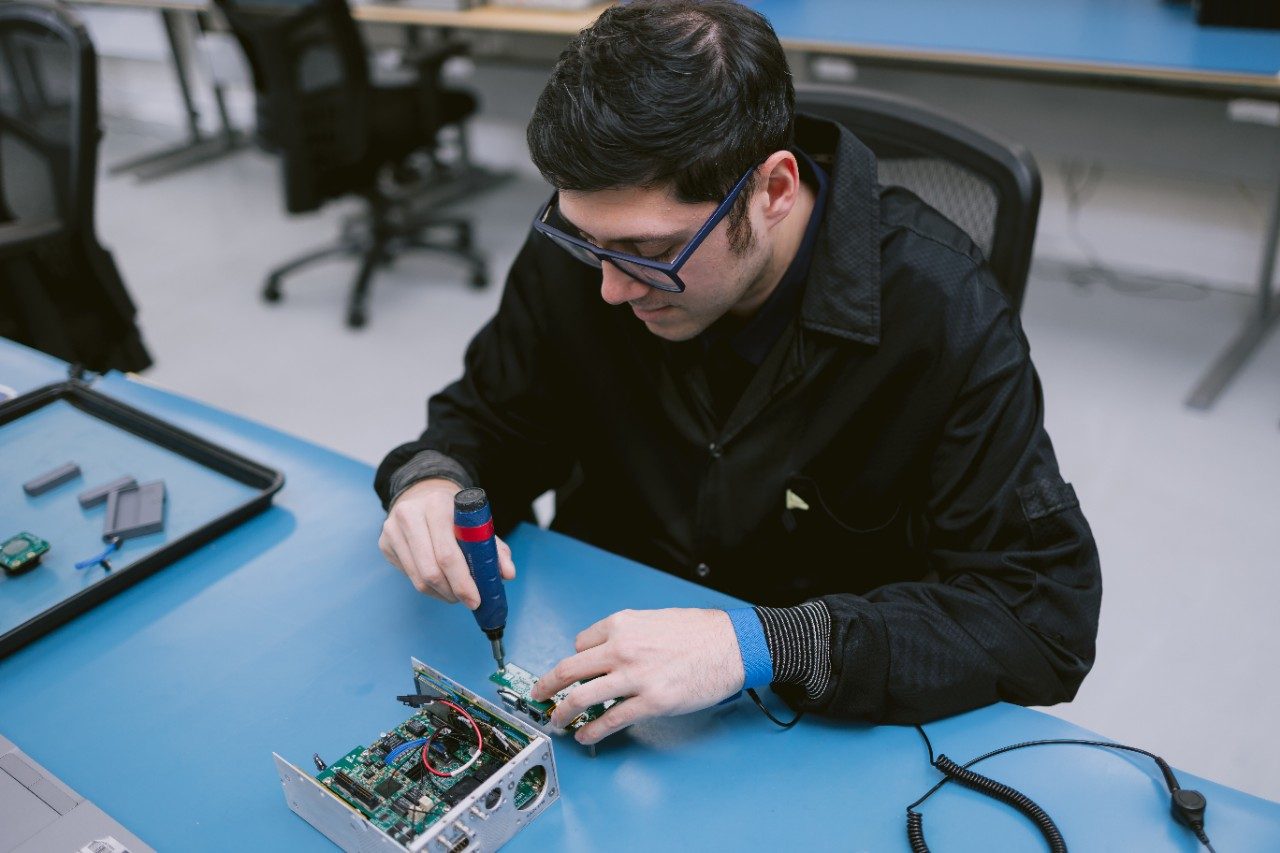 Aversan employee working on hardware components