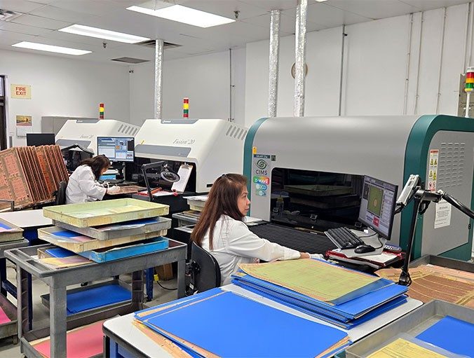 FTG circuits employee working on an assembly line