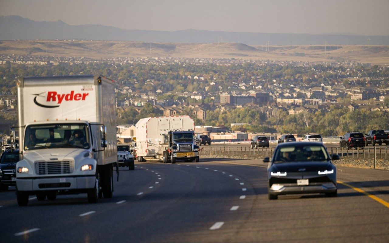 a truck carrying the GPS III SV07 satellite driving on Colorado’s C-470 highway